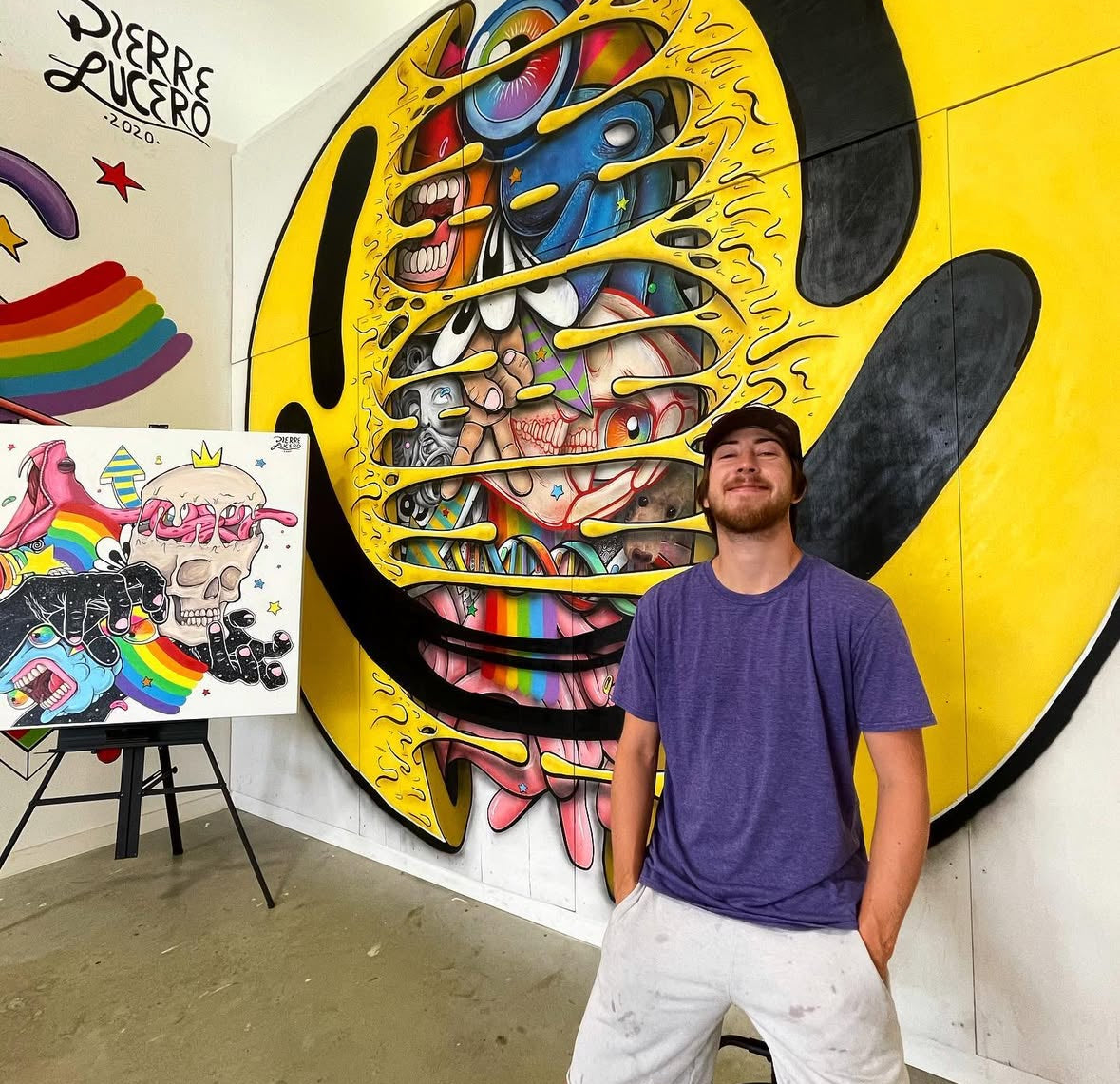 about the brand of sticker savages, the owner infront of a colorful mural.