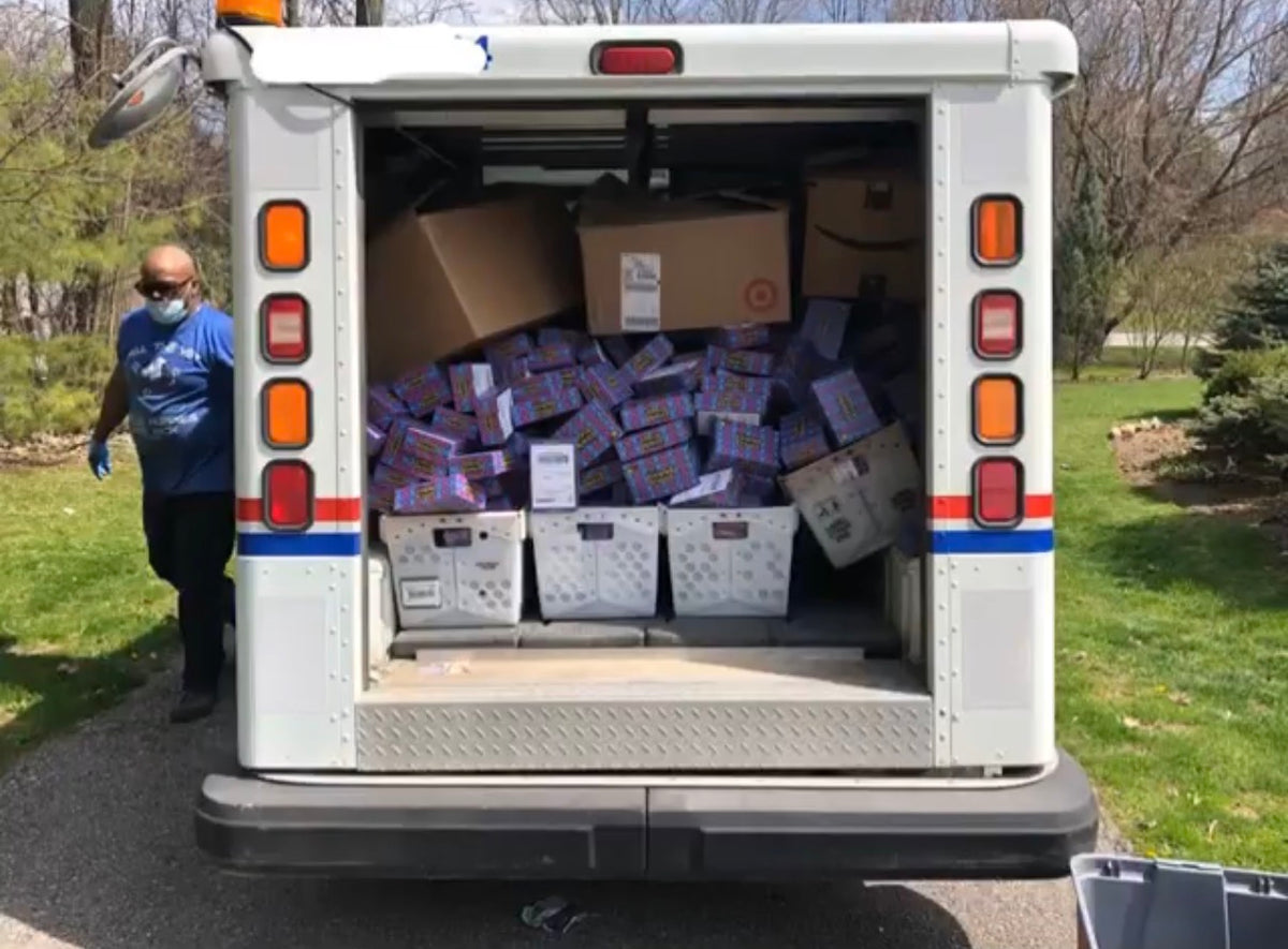 mail truck picking up sticker boxes full of stickers